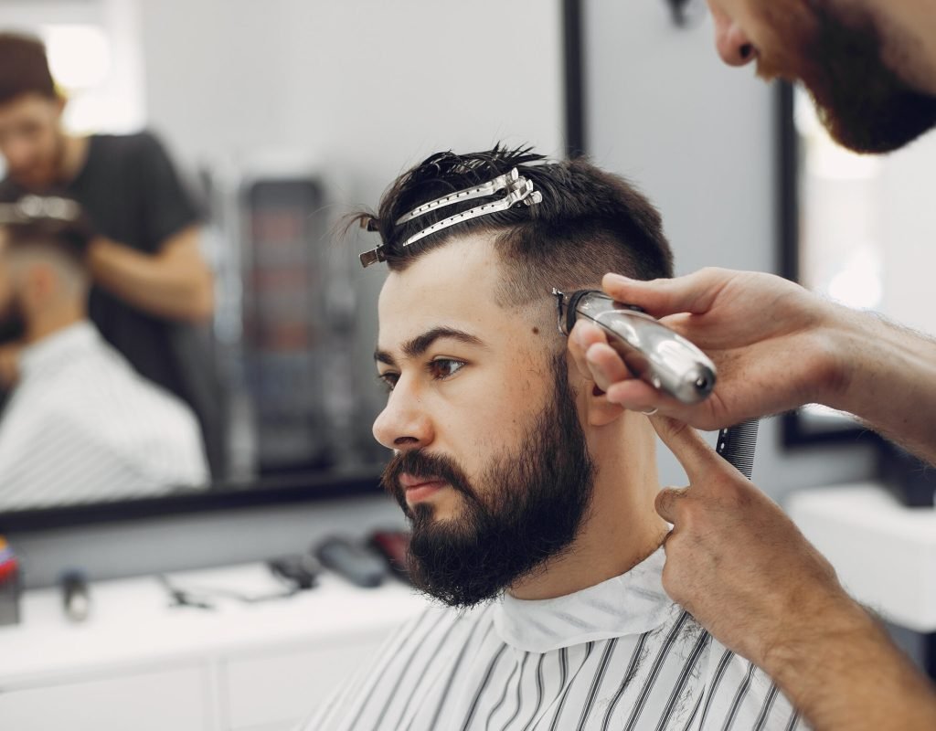 Man with a beard. Hairdresser with a client.